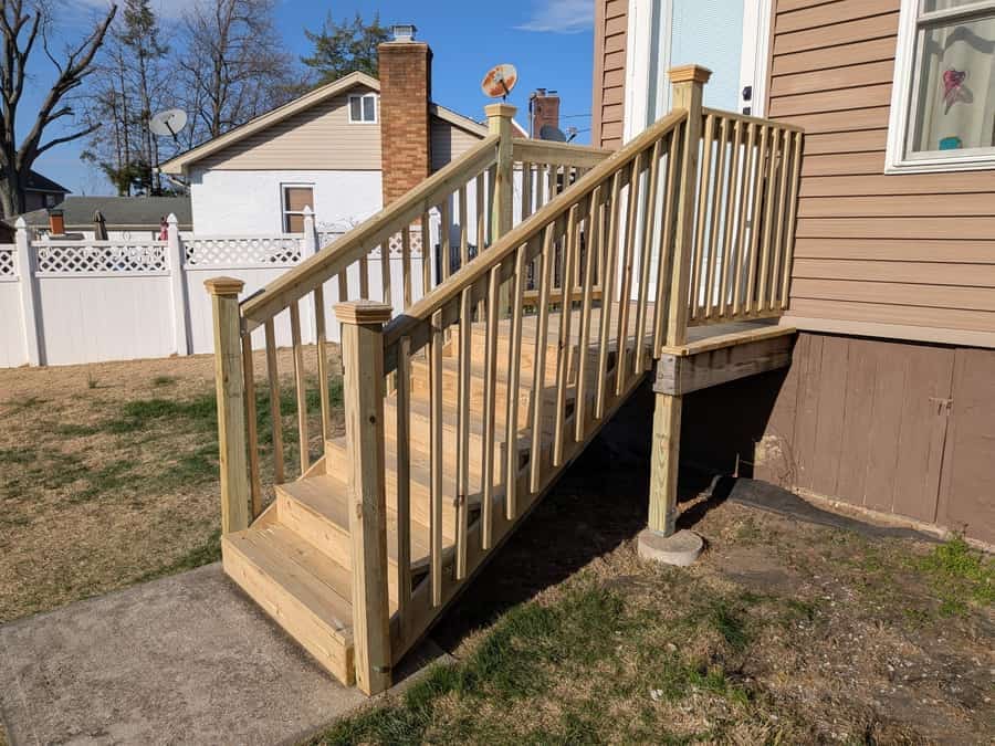 New pressure-treated deck stairs and railing built by East Brunswick Handyman in East Brunswick, NJ.